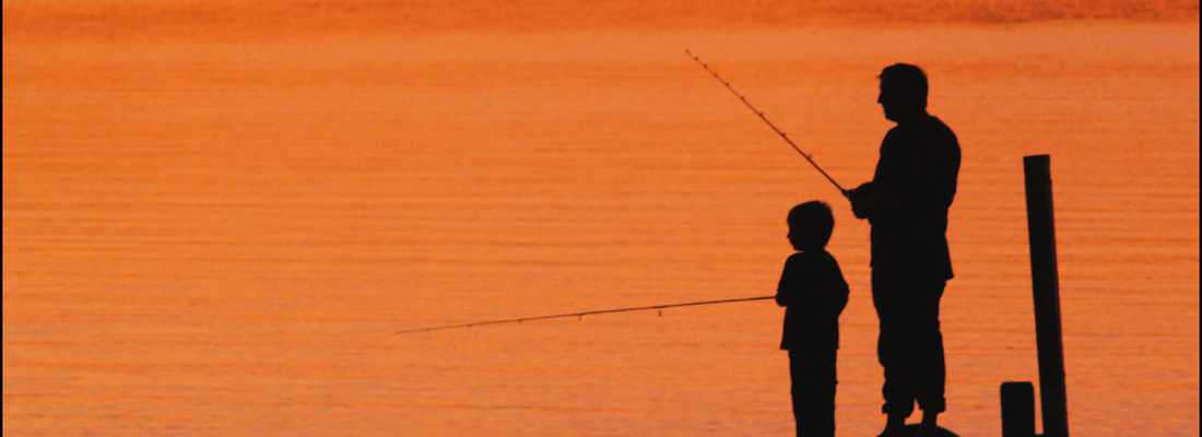 Father and son bait hooks for fishing on pier at Myrtle Beach State Park,  SC, USA Stock Photo - Alamy